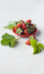 Strawberries in a bowl on a white background