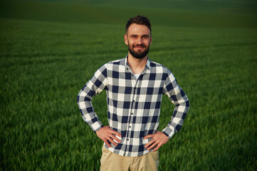 On agricultural field. Handsome young man