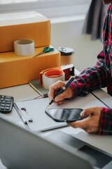 Close to entrepreneurs, small businesses, SMEs, freelance men working from home. Use a laptop for commercial auditing. online marketing Packaging Box SME Seller Concept Ecommerce Team online sales
