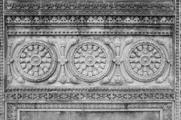 Decorative molding of oriental patterns on a cement-concrete wall in Nepal.
