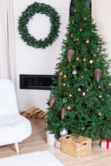 Cozy New Year's interior. Large Christmas tree decorated with bright garlands and golden stars in a cozy bedroom on Christmas Eve. Festive lights in the interior. Christmas background. Holiday magic.