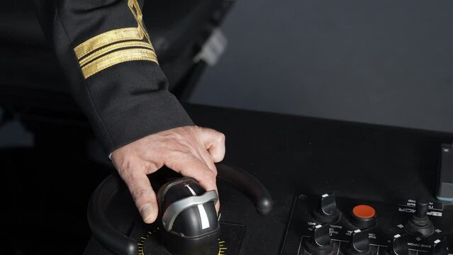 Vessel. Navigation bridge. Hand moves thruster. Officer steers vessel.