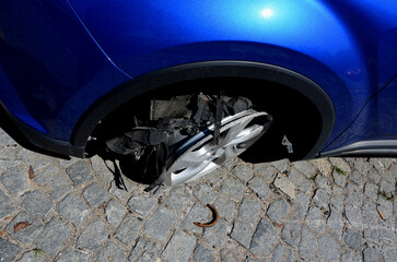 torn tire with holes in the side. the police chase ended with flat tires. rubber scratches and a...