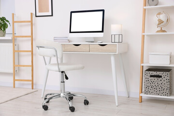 Workplace with comfortable office chair indoors. Interior design