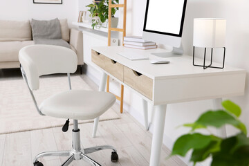 Workplace with comfortable office chair indoors. Interior design