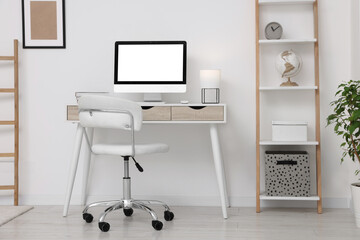 Workplace with comfortable office chair indoors. Interior design
