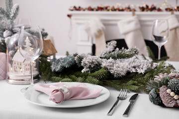 Beautiful festive table setting with Christmas decor in room