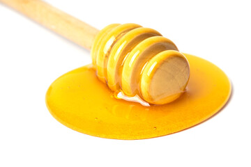 Honey dripping from dipper wooden honey stick isolated white background
