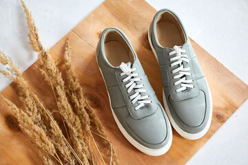 Fashionable suede sneakers. Sport shoes. Expensive footwear or loafers isolated on white background...