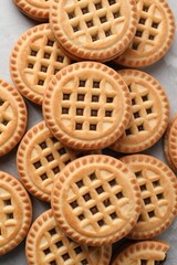 Tasty sandwich cookies with cream on grey table, flat lay