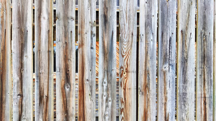 Fototapeta premium Fence made of wooden slats as a Location, Background, texture, copy of space, frame. Abstract natural graphic resource