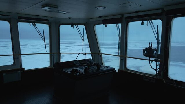 Ship. Navigation bridge. Control panel on wing. Frozen sea outside. Big windows with wipers. Vessel in ice.