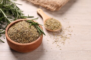 Bowl with dry and fresh rosemary on white wooden table, closeup. Space for text