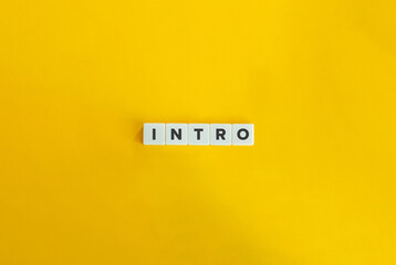 Intro Word and Concept. Block Letter Tiles on Yellow Background. Minimal Aesthetics. - obrazy, fototapety, plakaty