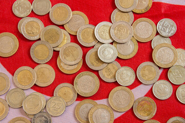 Turkish lira coins on a flag of Turkey