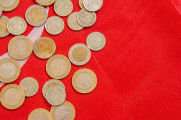 Turkish lira coins on a flag of Turkey