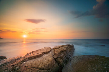 different rock forms and boats with sunset light