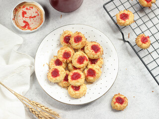 Homemade thumb print cookies filled with strawberry jam and grated cheese