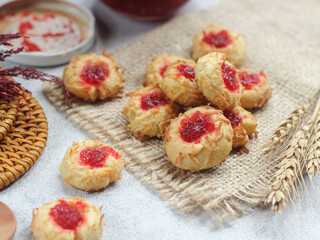 Homemade thumb print cookies filled with strawberry jam and grated cheese