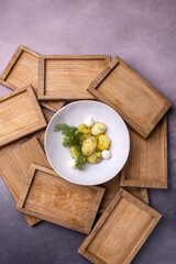 A bowl of potatoes with dill on top