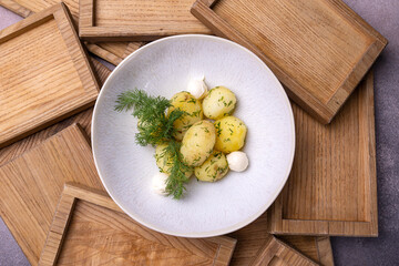 A bowl of potatoes with dill on top