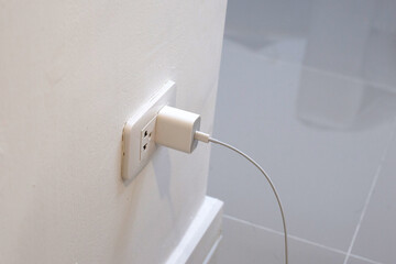 Hand insert a plug of the phone charger into socket.