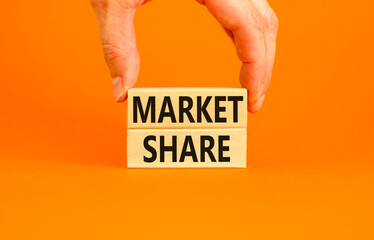 Market share symbol. Concept words Market share on beautiful wooden block. Beautiful orange table orange background. Businessman hand. Business and Market share concept. Copy space.