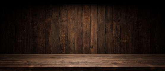 Old planks wall and table with light empty space. Vintage wooden background and spotlight showroom.