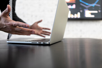 Crisis in business and bankruptcy concept. Close-up of hands gesture of businessman sitting at the desktop and working on computer