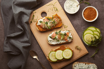 Healthy sandwiches with zucchini spread and natural yogurt, smoked salmon. Low in calories, FODMAP, KETO diet, superfood flat lay.