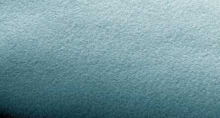 Green and grey felt fabric background. Surface of fabric texture in green turquoise color.
