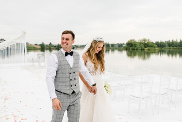 Naklejka premium Happy bride and groom after wedding ceremony on beach.