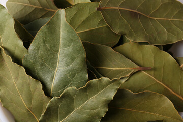 Pile of aromatic bay leaves as background, closeup