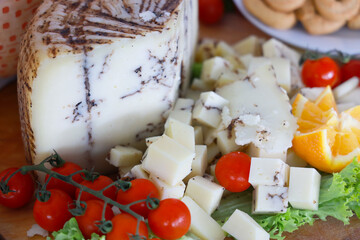 Truffle cheese with salad and tomatoes - antipasti. 