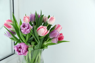 Obraz premium Beautiful bouquet of colorful tulip flowers indoors. Space for text
