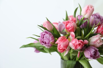 Beautiful bouquet of colorful tulip flowers against white background, closeup. Space for text