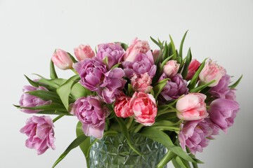 Beautiful bouquet of colorful tulip flowers against white background, closeup