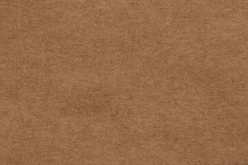 Fototapeta na wymiar Texture of brown paper sheet as background, top view