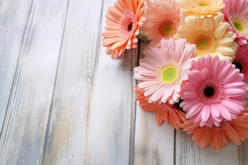 Colorful gerbera daisy bouquet on white wooden background, copy space for text. Pink, orange, red flowers. Floral greeting card mock-up for Mother's Day, Valentine's, Wedding invitation. Generative AI