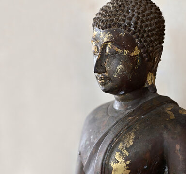 Black iron Buddha statue in the temple on white background