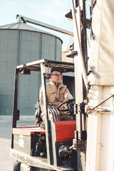 man working outside loading material with a lifting machine