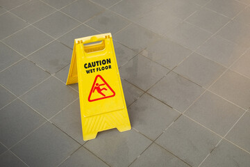 Yellow Caution Slippery Wet Floor Sign Showing and Warning of Caution Wet Floor on the Walk Way
