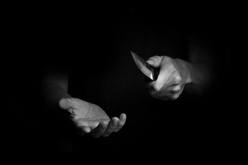 Adult Man Holding Sharp Knife in the Shadow. Black and White Concept Picture of Murderer, Killer,...