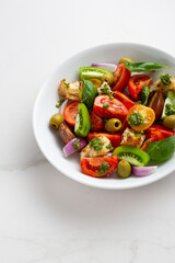 Close up of summer tomato salad with green pesto