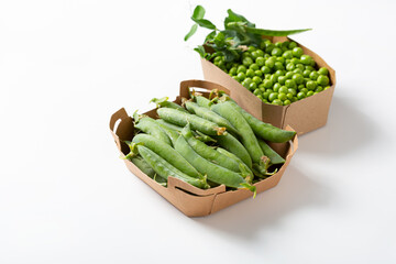 Green pea seeds and pod in carton container delivery food concept