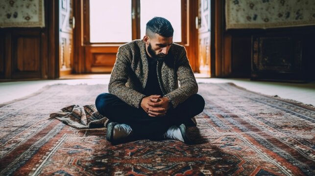 Thoughtful Man Sitting On Carpet At Home