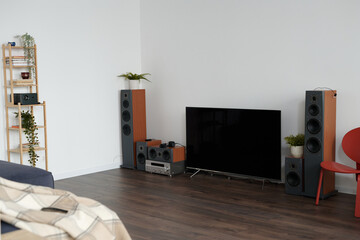 Horizontal image of contemporary living room with big TV and modern stereo system