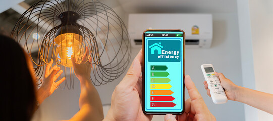 Woman change a new electric bulb, open air conditioning 26 degrees make a home more energy efficient. Home appliance energy efficient. Household equipment and energy class chart.