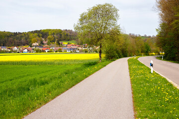 Idyllic Landscape: Pedestrian Road alongside a Highway through Fields in Germany