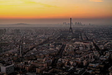 Fototapeta na wymiar Aerial view of Paris at sunset with the Eiffel Tower and La Défense business district in the background, as seen from the Tour Montparnasse, France